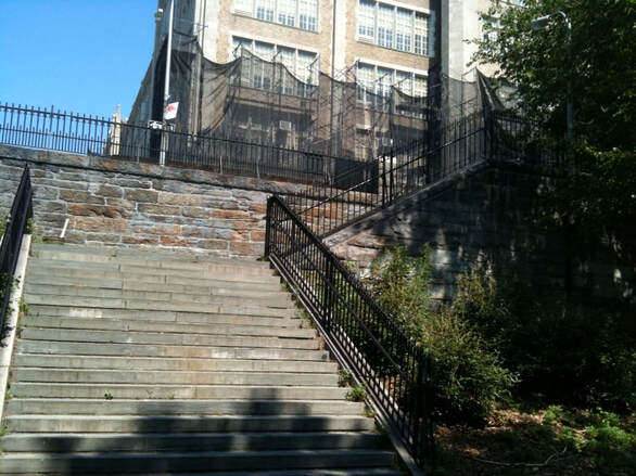 stone stairway leading to a tall building